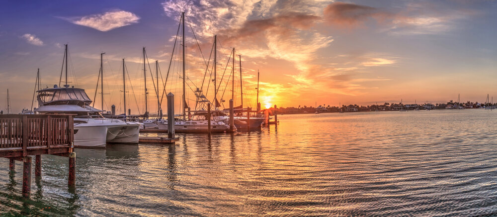 Break Of Dawn Sunrise Over Boats And Sailboats At Factory Bay Marina In Marco Island